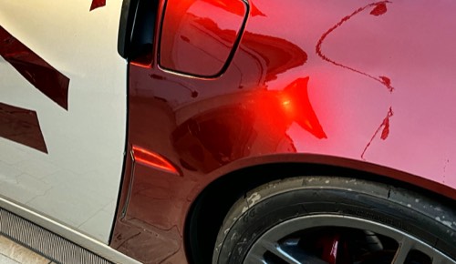 Candy red film laid over a panel, cut lines still visible