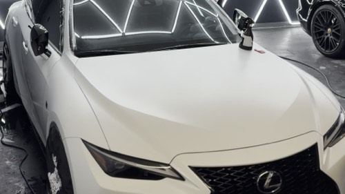 Finished satin white Lexus IS 350 under full light in the Obsidian Wrapz bay