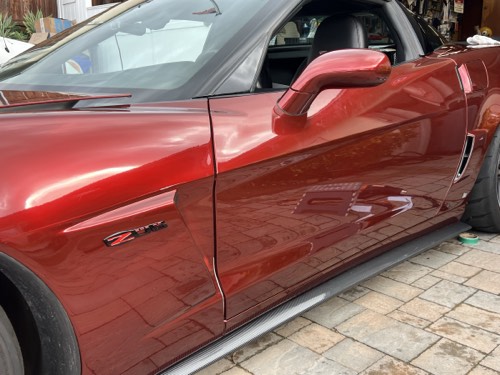 Vinyl being applied panel by panel to a Corvette